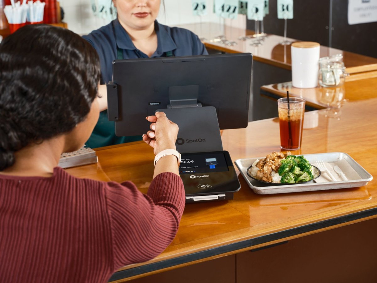 A customer paying by card at a restaurant counter